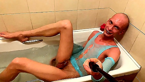 Totally shaved skinny femboy takes a bath in a cute outfit
