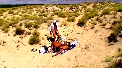 Gay threesome on the  beach